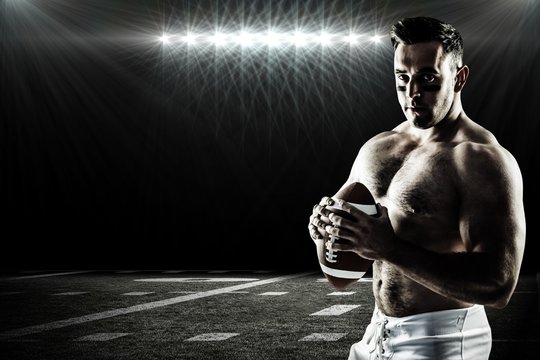 Composite image of shirtless american football player with ball
