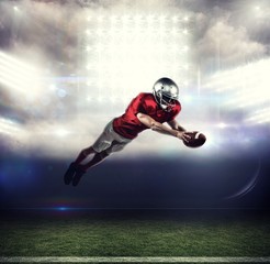 Naklejka na ściany i meble Composite image of american football player scoring a touchdown