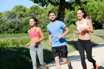 Fototapeta na wymiar group of young healthy fitness people running outdoor in summer