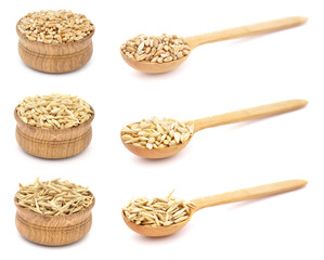 Wheat, barley, oat in wooden bowls and spoons