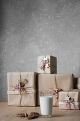 Christmas gift boxes decorated with lace and stars next to a glass of milk and cookies, lifestyle, holiday, gift, celebrate, greeting
