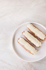 Eclairs on white marble