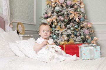 A little girl near the Christmas tree