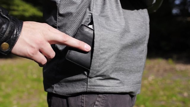 Hand steals wallet from pocket.