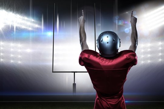 Composite image of american football player with arms raised