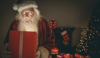 Santa claus delivering a glowing gift
