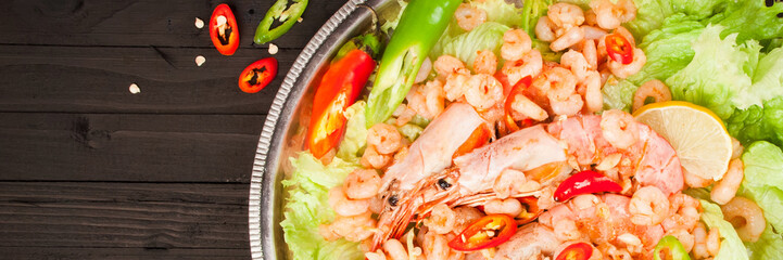 Fried shrimp on a wooden background. Top view