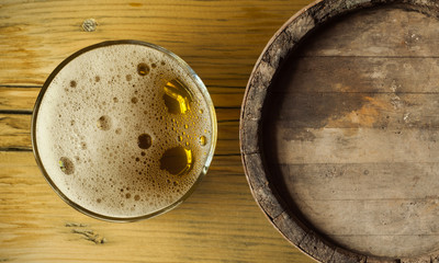 Beer barrel with  glass on table  wooden background