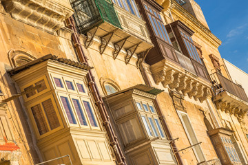 Typical ancient houses and balconies of Valletta at sunrise - Malta