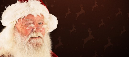 Composite image of santa claus winking