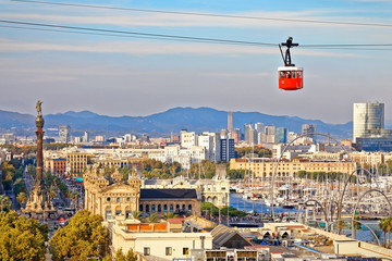 Red cabin of cableway stands out on Barcelona's port - obrazy, fototapety, plakaty