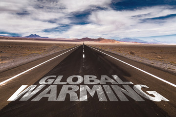 Global Warming written on desert road