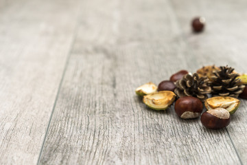 Chestnuts and Pine Cones on wooden Table