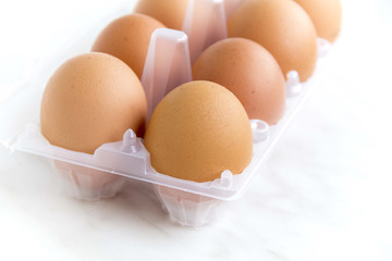 Brown chicken eggs in plastic packaging
