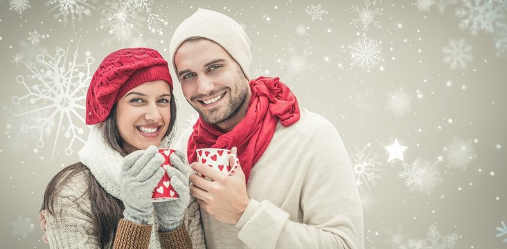 Composite Image Of Winter Couple Holding Mugs