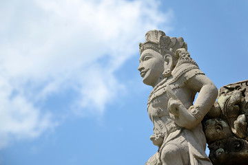 Fototapeta na wymiar Bali style sculpture and blue sky in hindu temple at indonesia