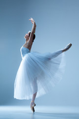 Naklejka premium Portrait of the ballerina on blue background