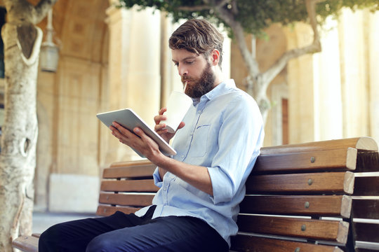 Bearded man sitting on a bench