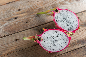Half of Dragon fruit on wooden table.