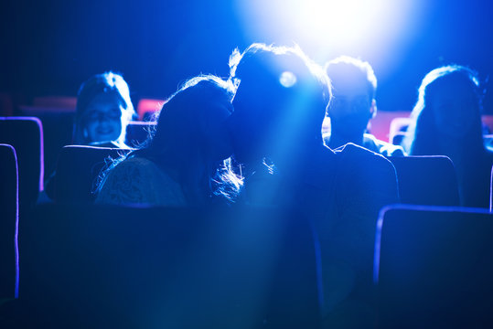 Couple kissing at the cinema
