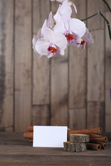 Orchid  and paper on wood background