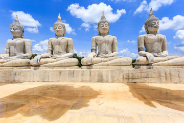 Fototapeta na wymiar Buddha statue and blue sky, Nakhon Si Thammarat Province, Thailand