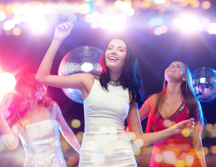 happy women dancing at night club
