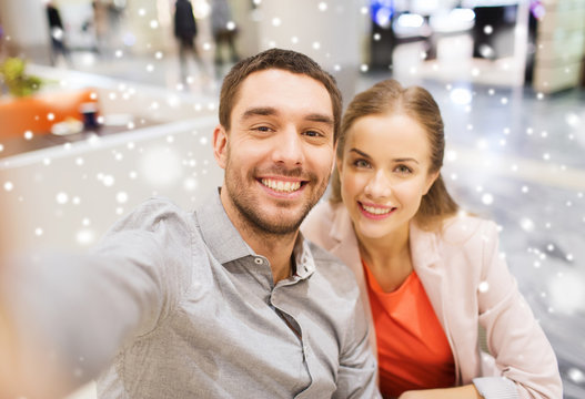happy couple taking selfie in mall or office