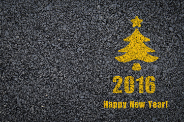 Happy new year and fir-tree written on an asphalt road background