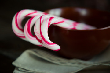 Candy cane on a wooden table