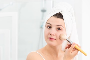 Female applying face powder