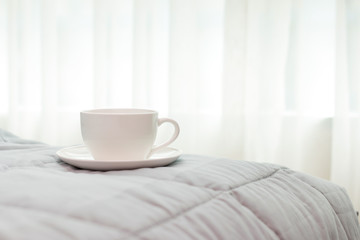 Fototapeta na wymiar coffee cup in the morning on the bed background