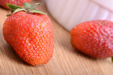 Strawberry set on wooden plate close up