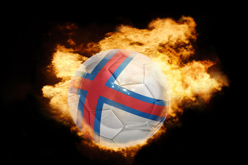 Fototapeta premium football ball with the flag of faroe island on fire