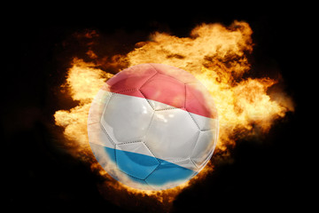 football ball with the flag of luxembourg on fire