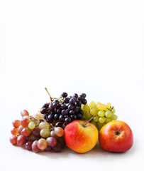 Fruity harvest background. Apples and grapes on a white. 