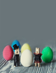 Surprise egg. Creative design easter card. Abstract love concept with clothespin heroes