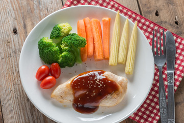 Grilled chicken steak in bbq sauce and vegetable. Top view.