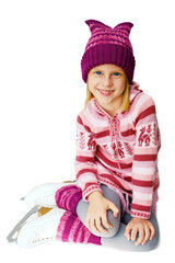 Ice skating. The little girl sitting on ice in ice skating.