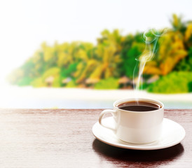 Cup of coffee on table on bright background