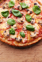 Tasty pizza with vegetables and basil on table close up