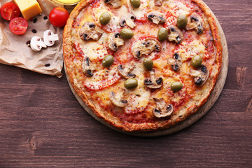 Tasty pizza with vegetables and cheese on table close up