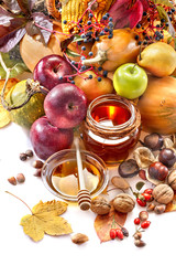 Honey, apples and autumn fruits on the white background
