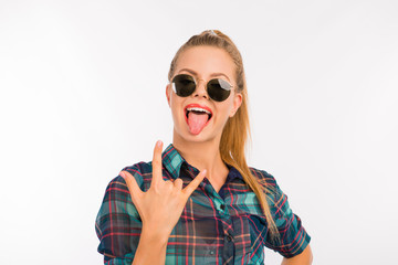 funny gesturing girl in a checkered shirt with glasses showing t