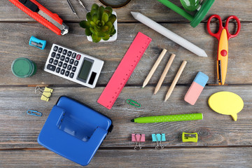 Bright stationery objects on wooden table close up
