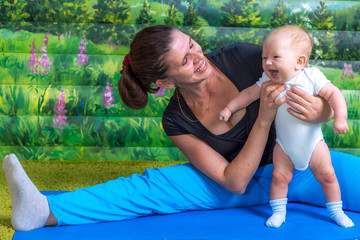 Mother with baby doing gymnastics