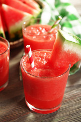 Glasses of watermelon juice on wooden table, closeup