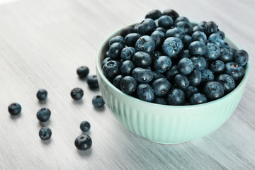 Fresh blueberries in bowl on table close up