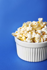 Salted popcorn on blue background