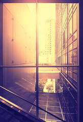 Vintage stylized picture of modern office at sunset, NYC, USA.